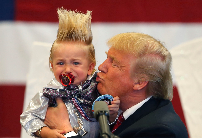 Donald Trump holds a Lil Trump he “pulled from the crowd” in New Orleans (AP Photo/Gerald Herbert)